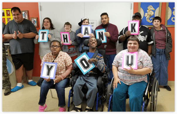 Group of people holding thank you sign